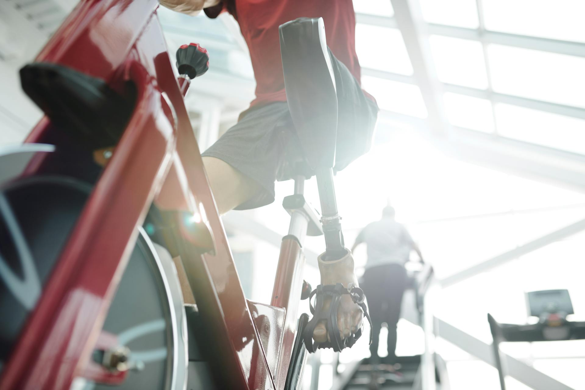 Man in Red T-shirt Riding a Stationary Bike