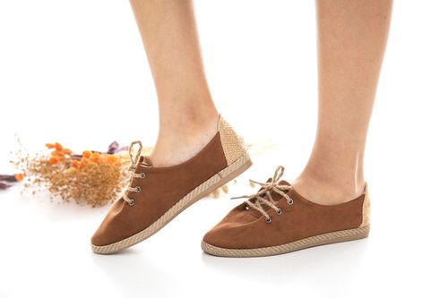 Free Stylish brown suede sneakers with lace ties, perfect for casual fashion. Stock Photo