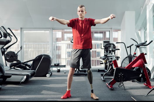 A man with a prosthetic leg performs exercises in a gym, embodying determination and fitness.