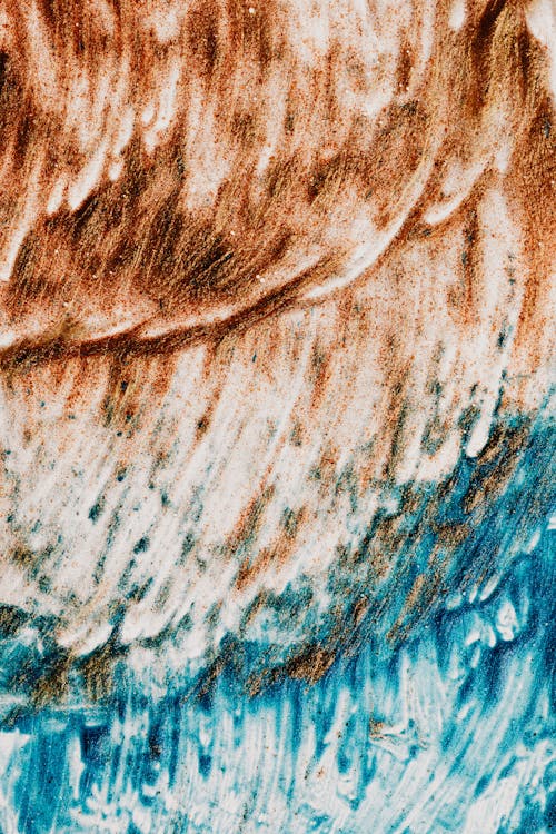 Closeup of picture of sea and ground made of blue and brown dye
