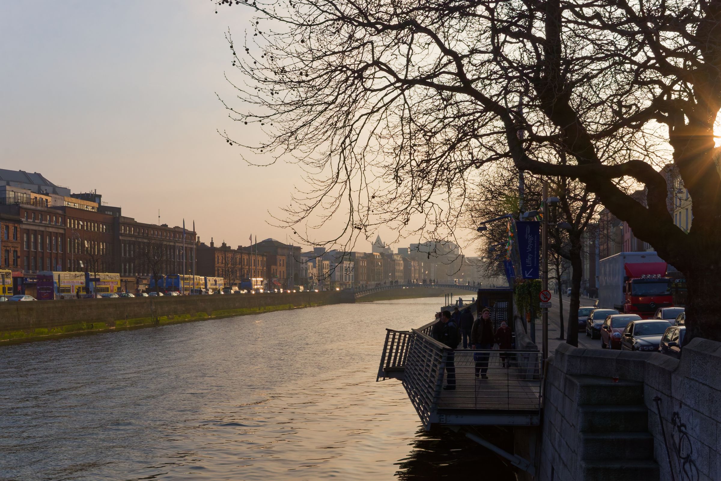 A view of Dublin's Liffey River at sunset, highlighting city life and architecture