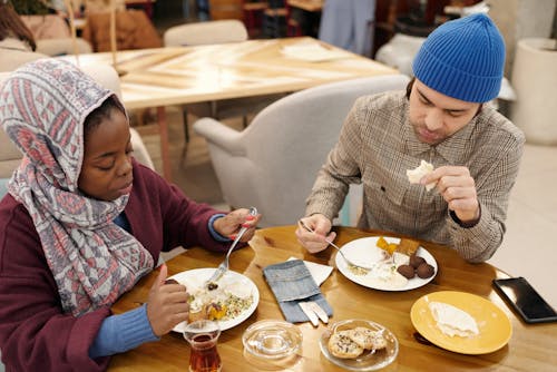 Free Muslim Couple Eating in Restaurant Stock Photo