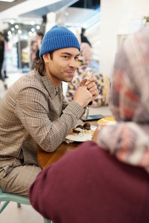 Free Muslim Couple Eating in Restaurant Stock Photo