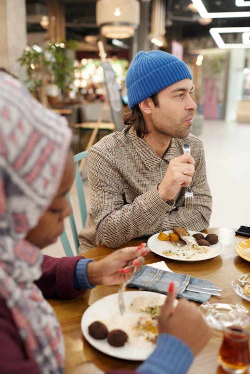 Free Muslim Couple Eating in Restaurant Stock Photo