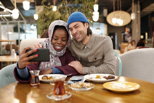 Couple Taking Selfie While Eating