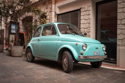 Blue Car Parked Beside a Doorway