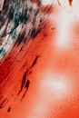 Abstract ink background with black dirty flow on red surface