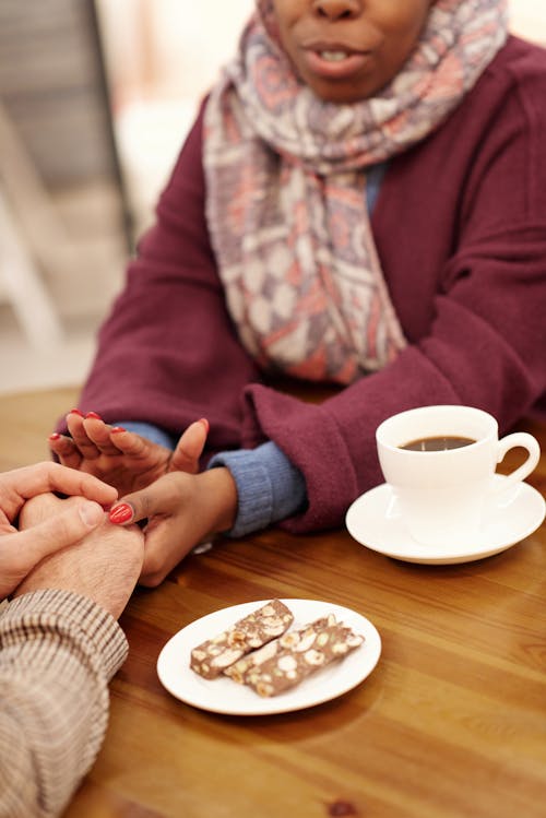 Couple Holding Hands Over Table