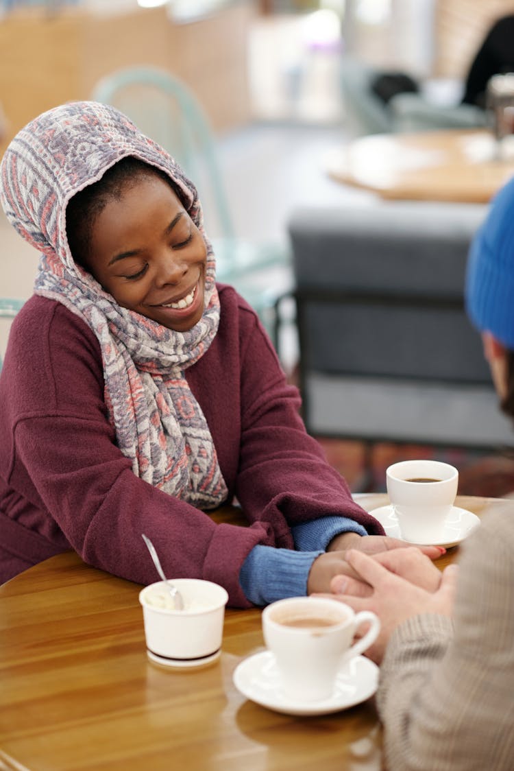 Couple Holding Hands Over Table