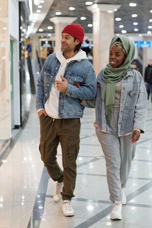 Free Muslim Couple Walking in Shopping Mall Stock Photo