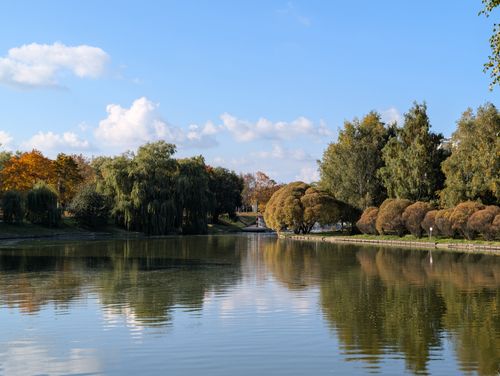 Free Serene autumn landscape with trees reflecting in a park lake in Minsk, Belarus. Stock Photo