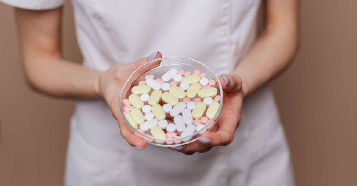 Close-up of a medical professional holding a petri dish filled with pills and tablets. - Evidence evidence guide for quercetin skin health randomized trial