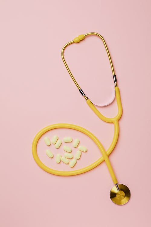 Free Stethoscope And Pills On Pink Background Stock Photo