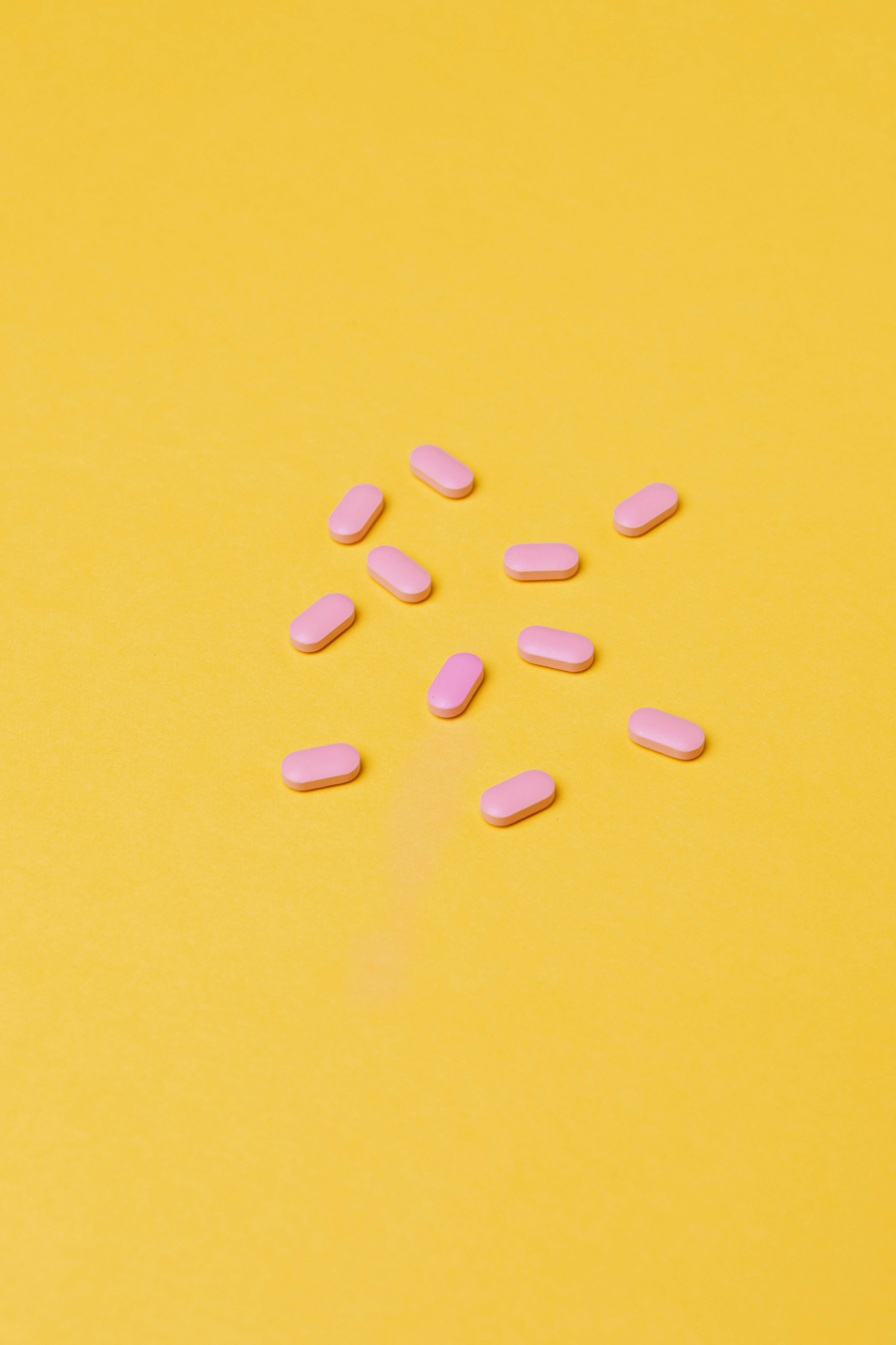 Pink Medicines On Yellow Background · Free Stock Photo
