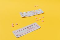 Pink Pills on Yellow Surface