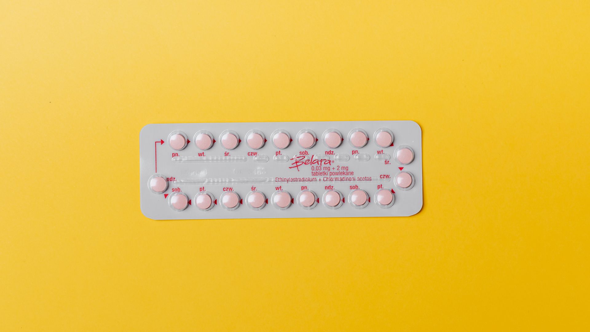 modafinil tolerance break schedule: The Ultimate Guide Close-up of a blister pack of pink pills on a vivid yellow background for medication concept — modafinil tolerance break schedule
