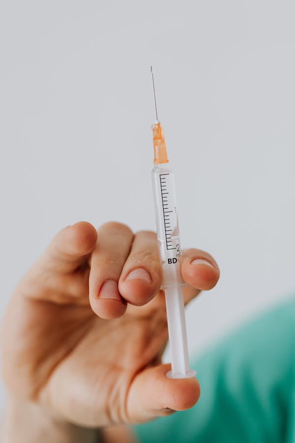 Close-up View Of Person Holding A Vaccine