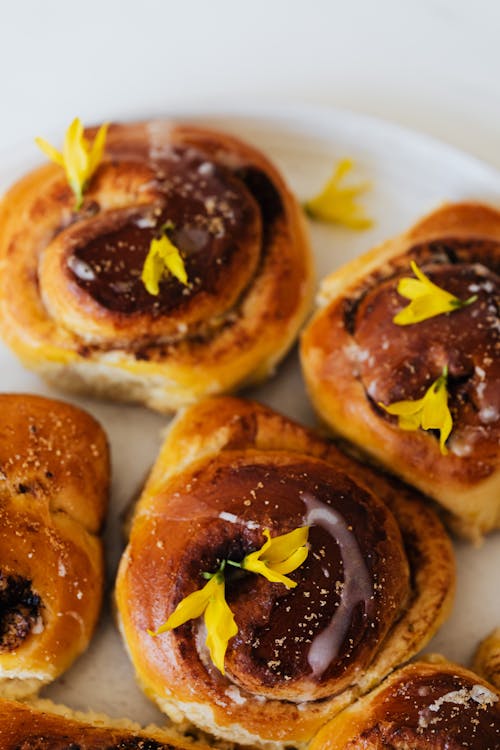 Close Up Photo of Brown Roll Breads wwith Yellow Petals