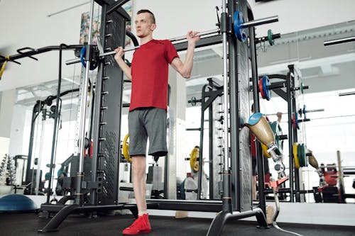 Free Photo Of Man In Red Shirt Lifting Barbell Stock Photo