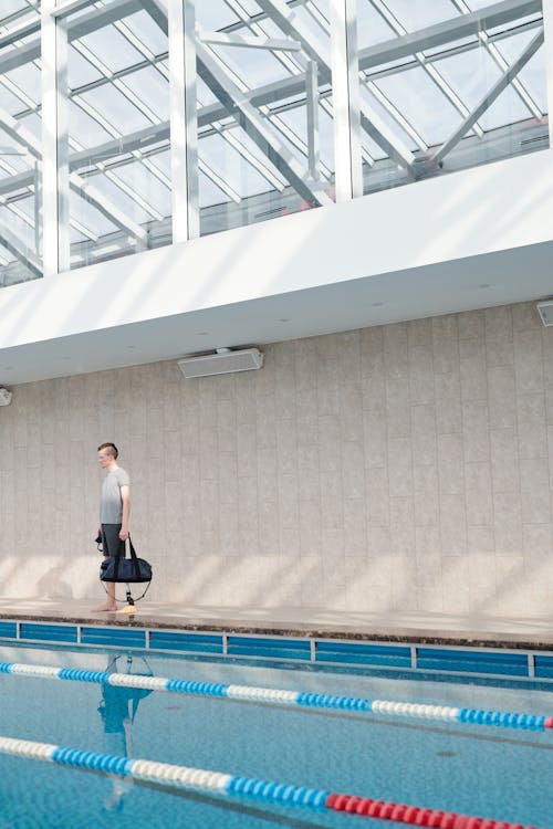 Free Man Standing at the Poolside Stock Photo