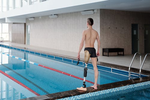 Man in Black Shorts Standing on Swimming Pool