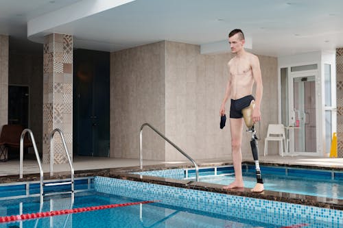 Man in Black Shorts Standing on Swimming Pool