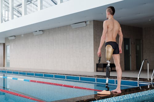 Man in Black Shorts Standing on Pool