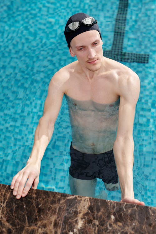 Free Man in Black Shorts Standing on Swimming Pool Stock Photo