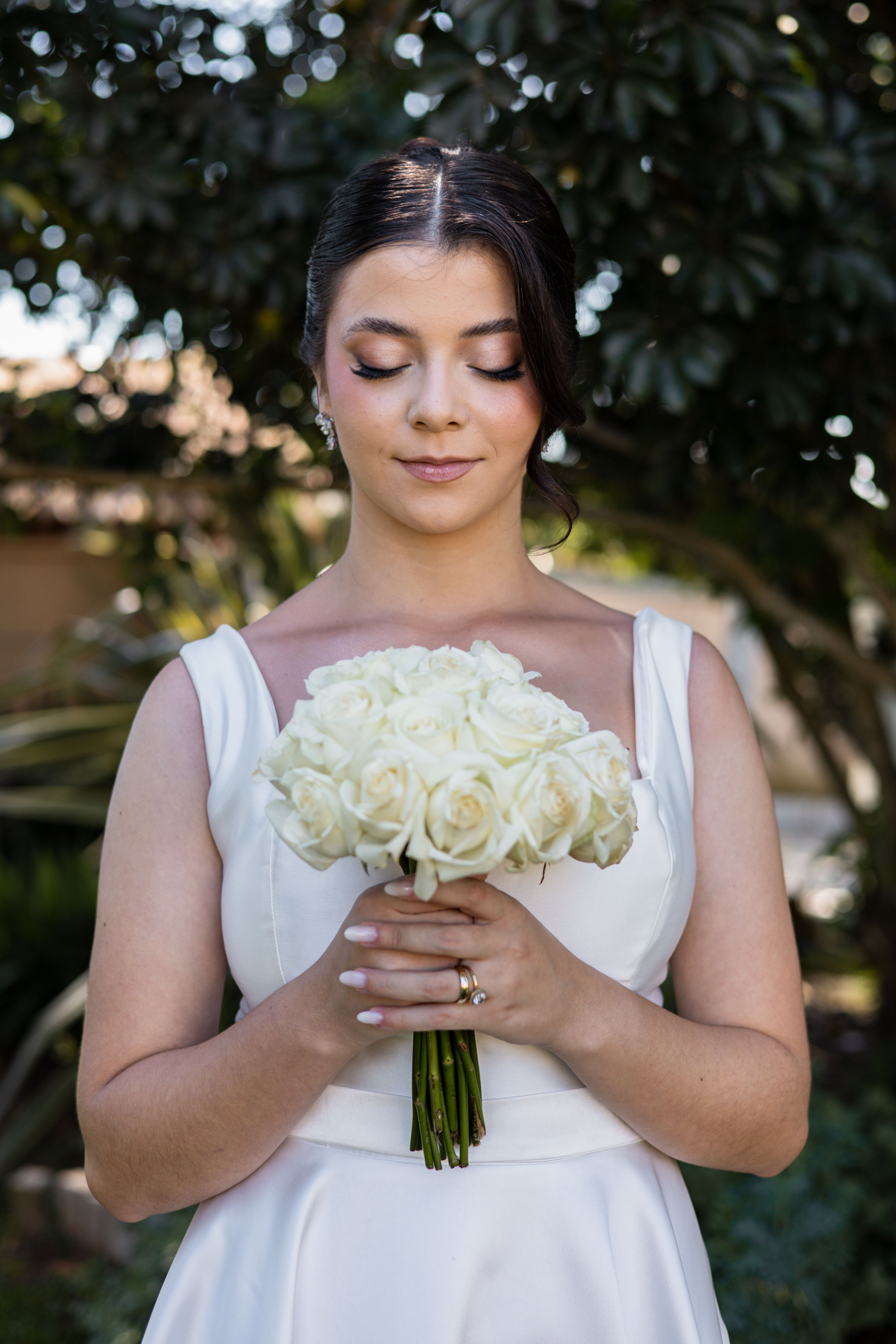 Elegant Bride Holding White Rose Bouquet Outdoors · Free Stock Photo