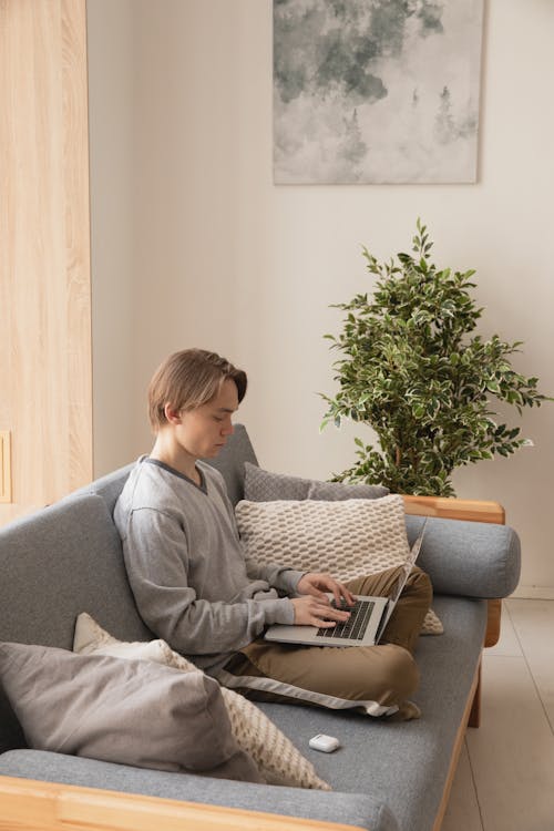 Man Sitting on the Couch with His Laptop