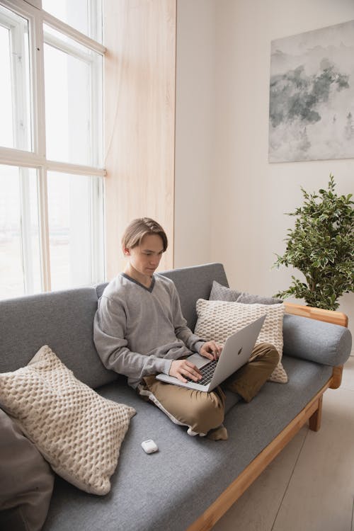 Man Sitting on the Couch with His Laptop