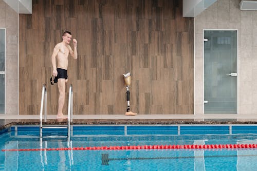 Man in Black Shorts Standing on Swimming Pool