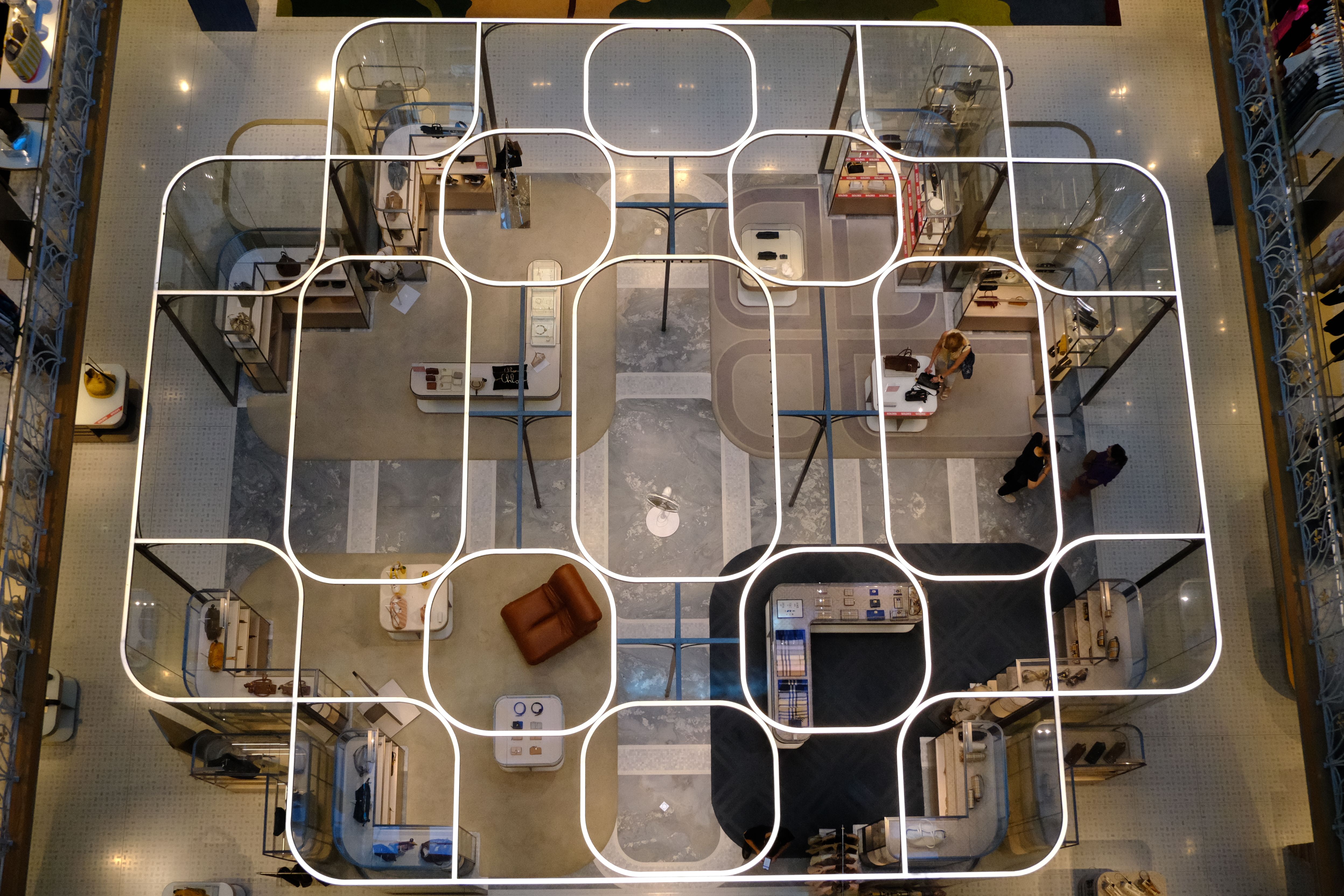 Aerial view of a modern retail store with a unique grid-like design and shopping areas.