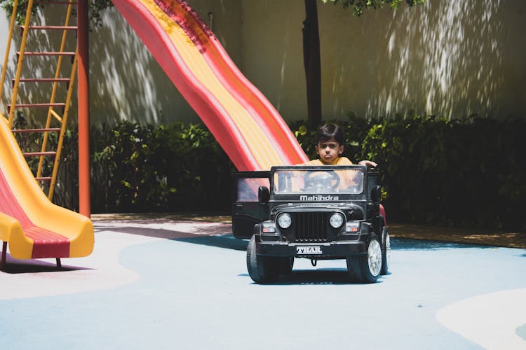 Child Driving A Ride On Toy Car