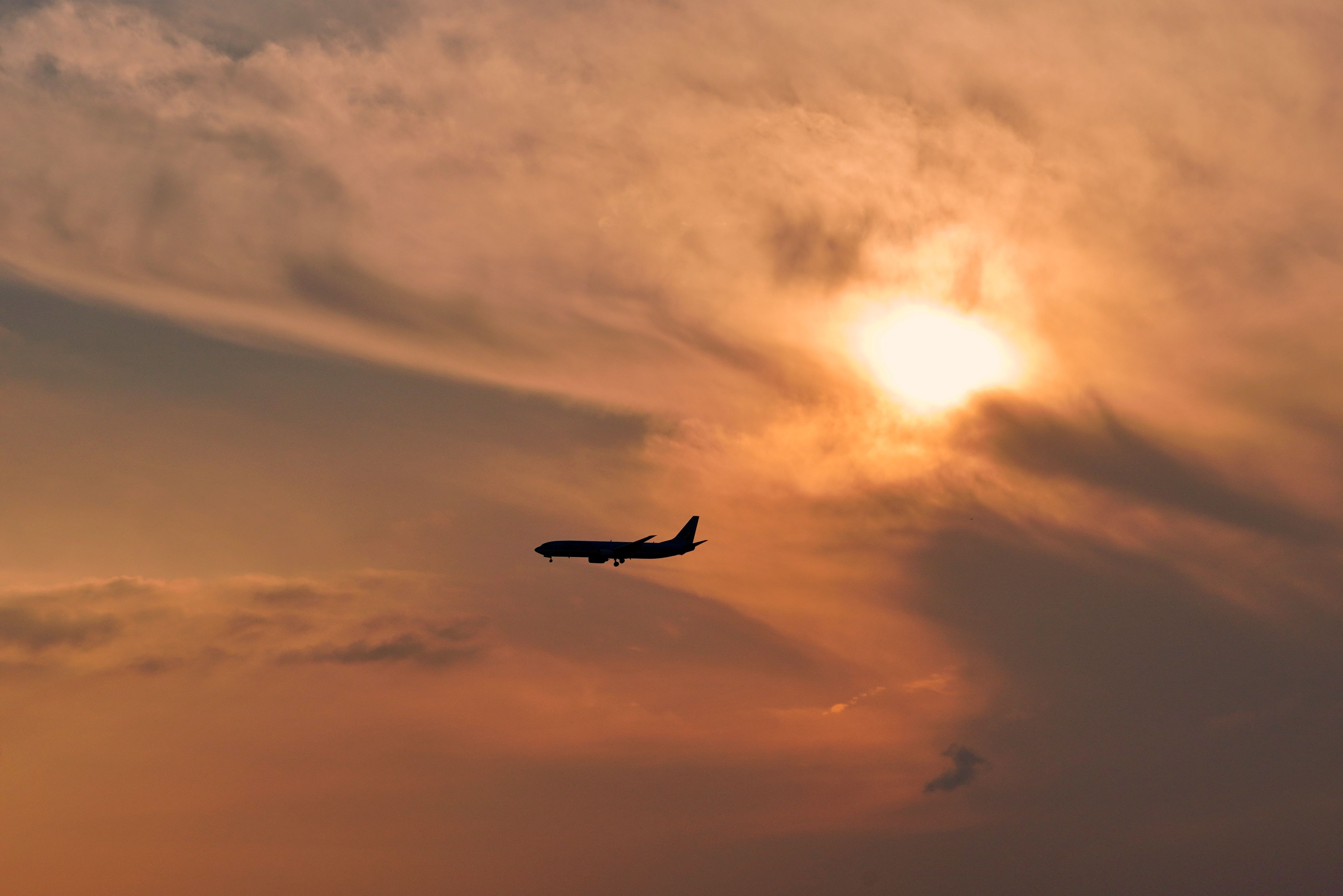 Airplane Silhouette Against Dramatic Sunset · Free Stock Photo