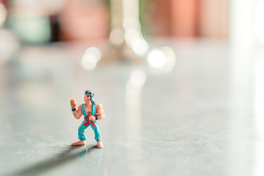 Selective Focus Photography of Male Character Figurine