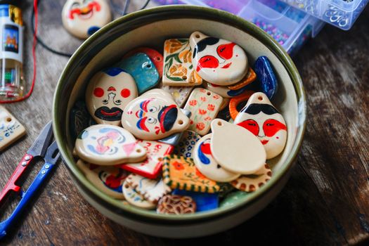 Vibrant ceramic art pieces in a bowl showcasing traditional Vietnamese craftsmanship.