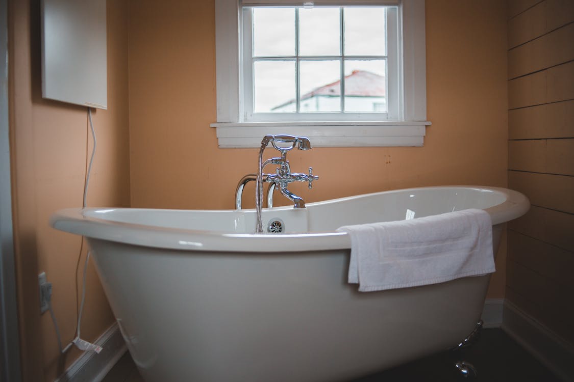 Free Photo Of Ceramic Bathtub Near Window Stock Photo