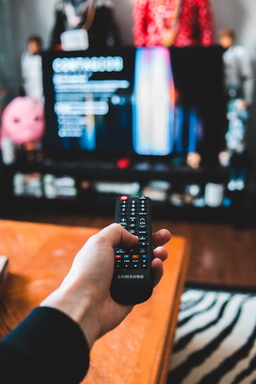 Photo Of Person Holding Remote Control 