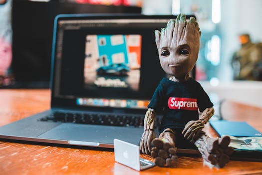 Creative setup with a Groot toy sitting next to a laptop, showcasing a modern work-from-home environment.