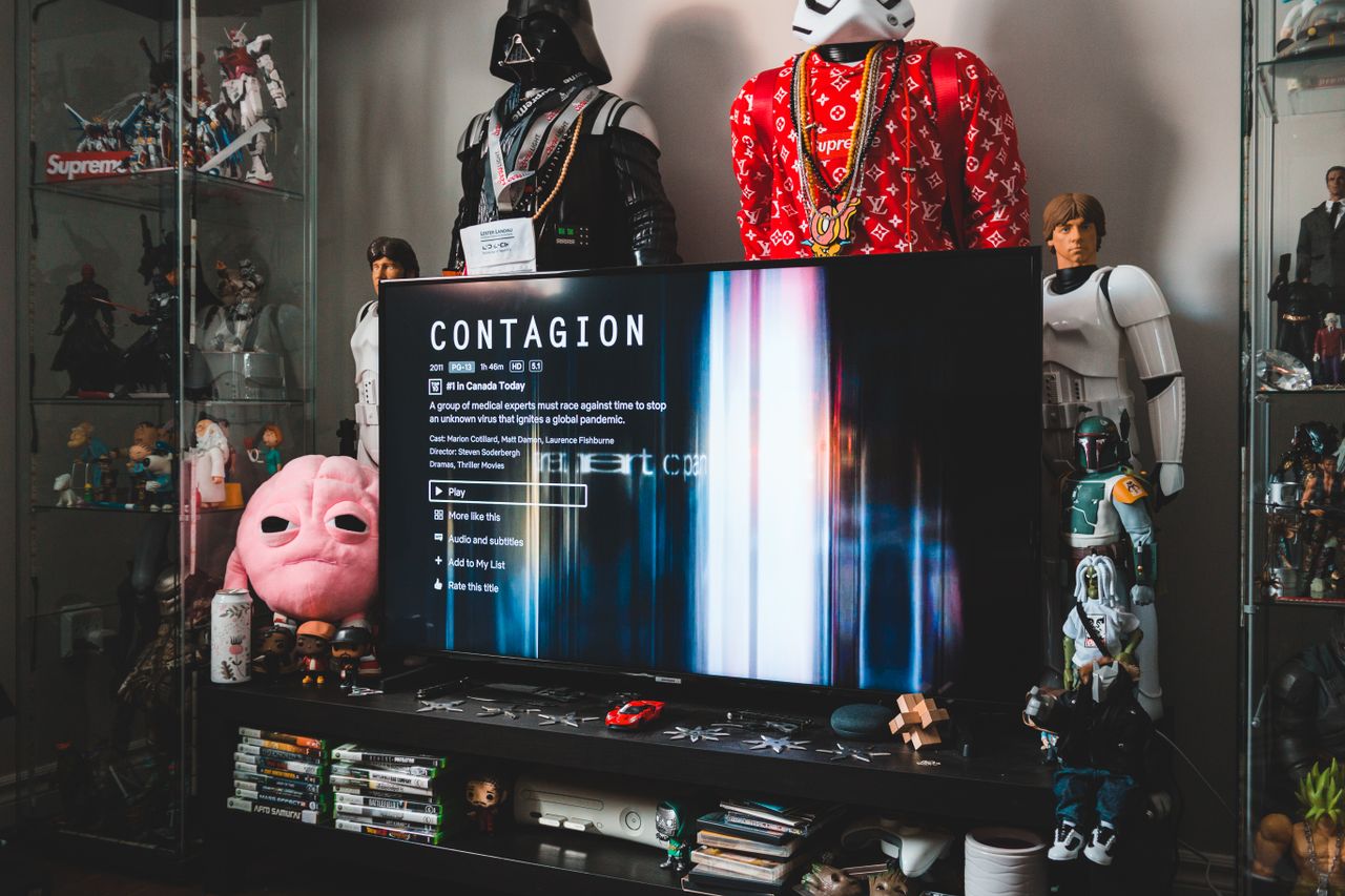 desktop computer with creative video game on screen near assorted toy