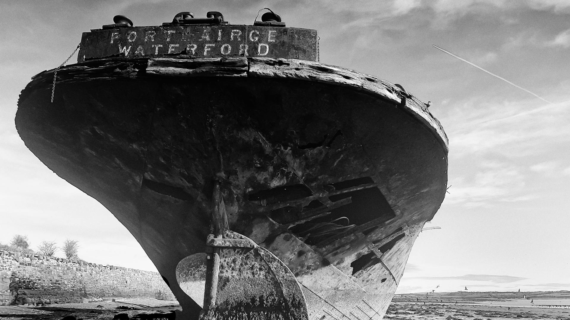 Monochrome image of an abandoned shipwreck at Wexford Harbor, Ireland.