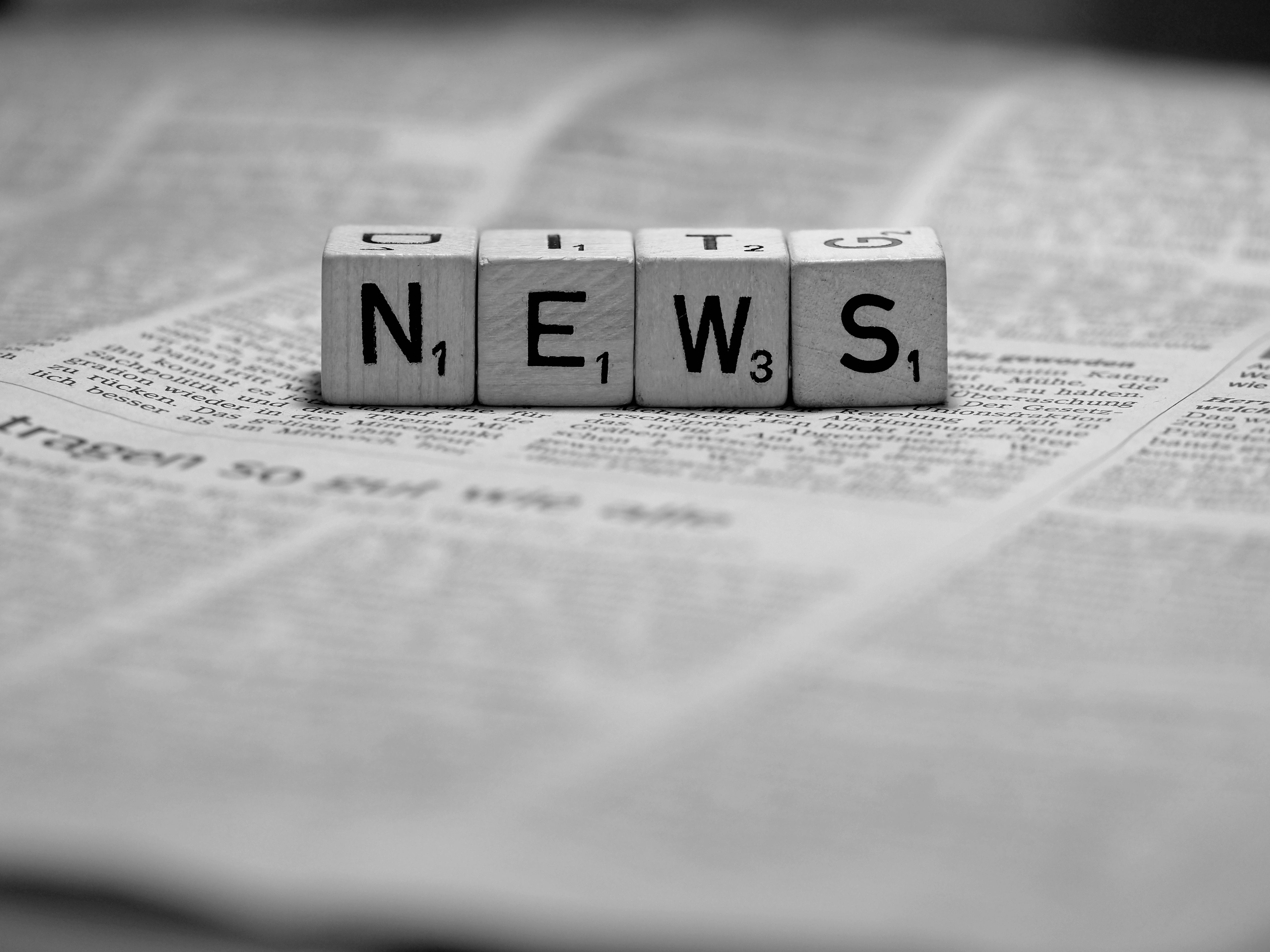 Black and White News Dice on Newspaper · Free Stock Photo