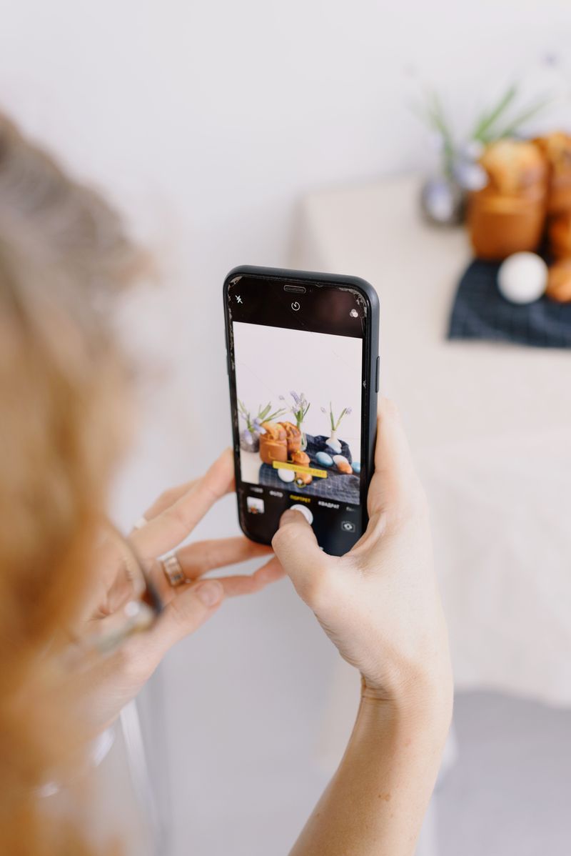 Person photographing freshly baked food with a smartphone