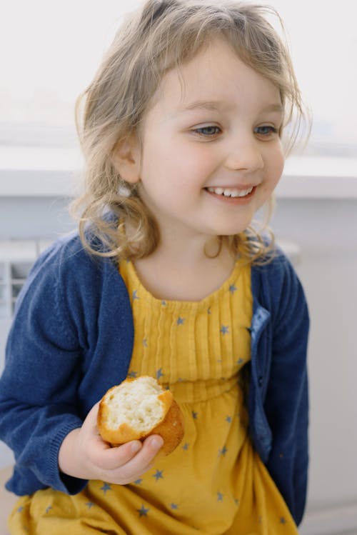 Free Photo Of Child Holding Bread Stock Photo