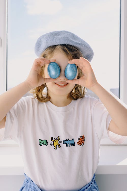 Little Girl Holding Blue Eggs