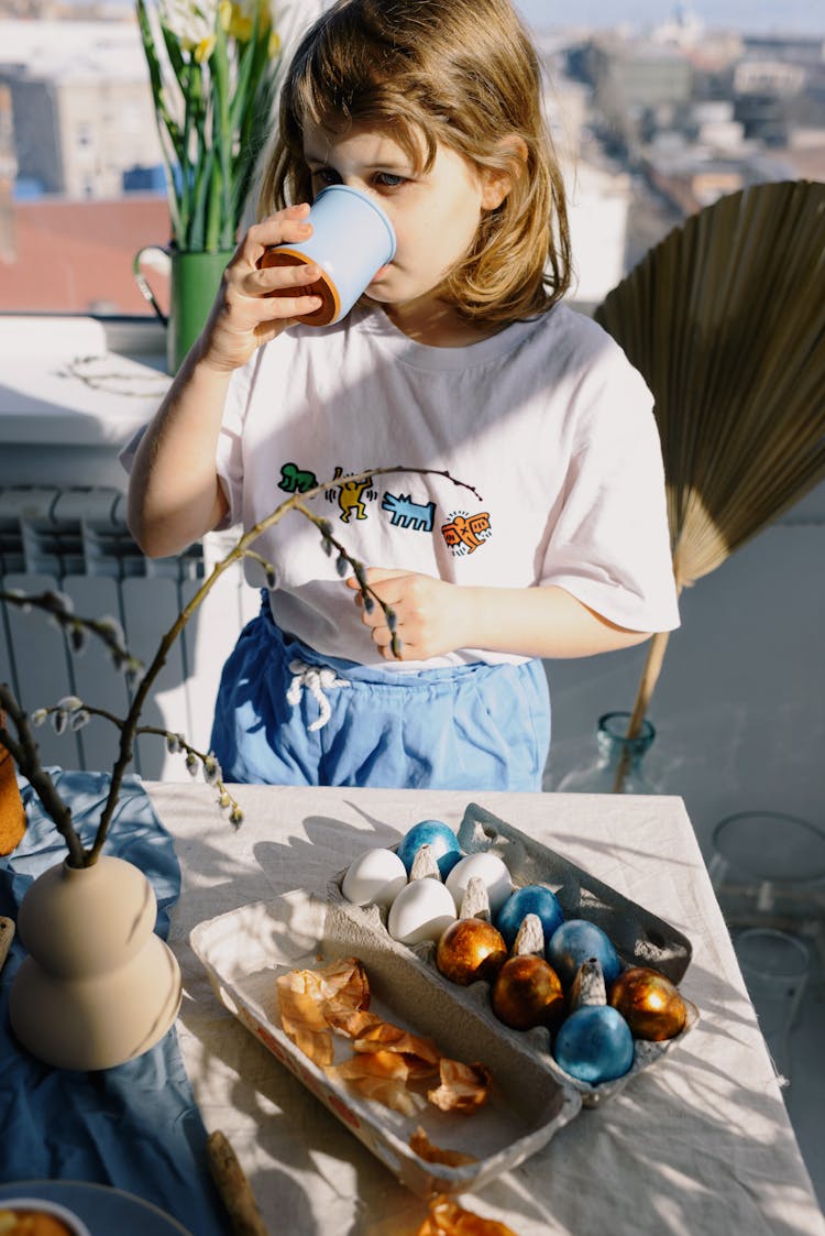 Little Girl Drinking From A Mug