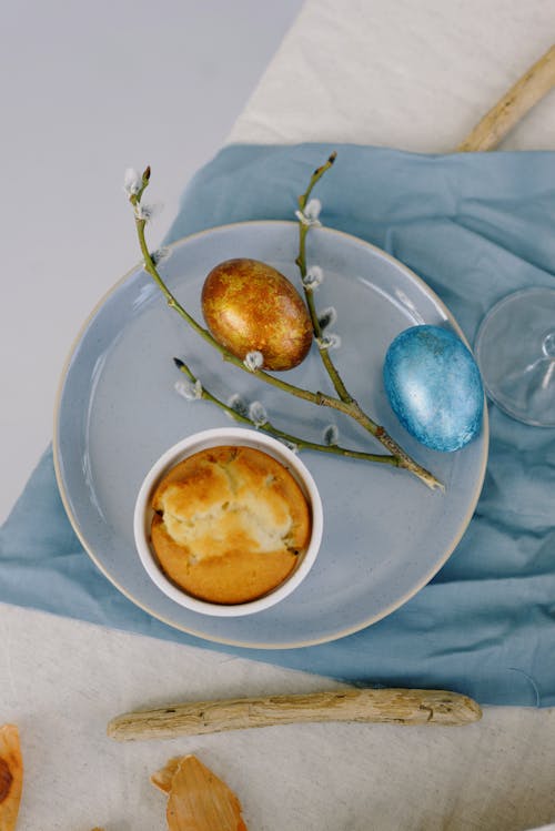 Muffin and Easter Eggs on a Ceramic Plate