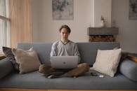 Photo Of Man Sitting On Sofa