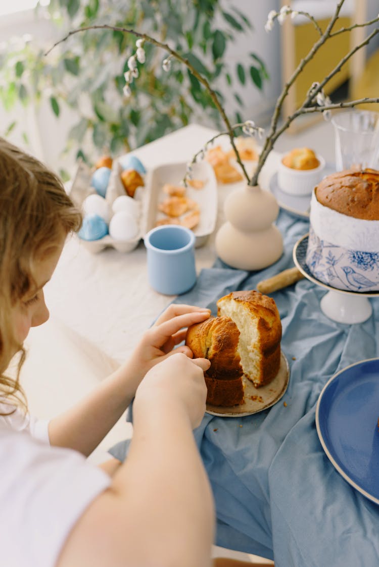 Little Girl Cutting A Cake